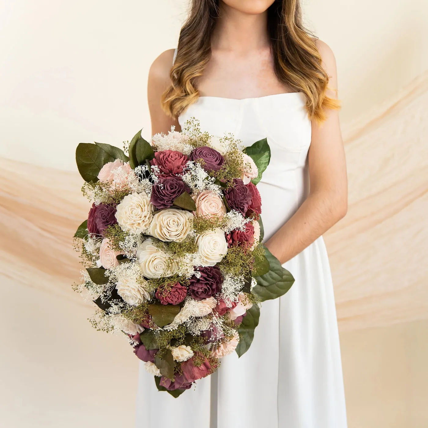 Bride holding the Love Story bouquet in burgundy, eggplant and powder pink