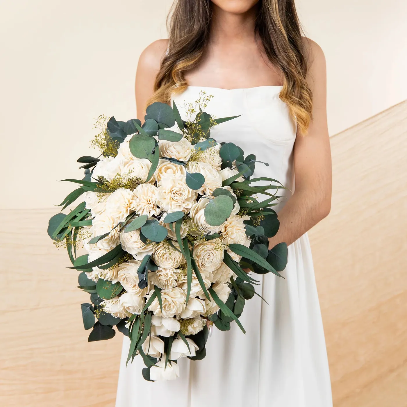 Bride holding the Perfect Simplicity bouquet of raw cream wood flowers and eucalyptus