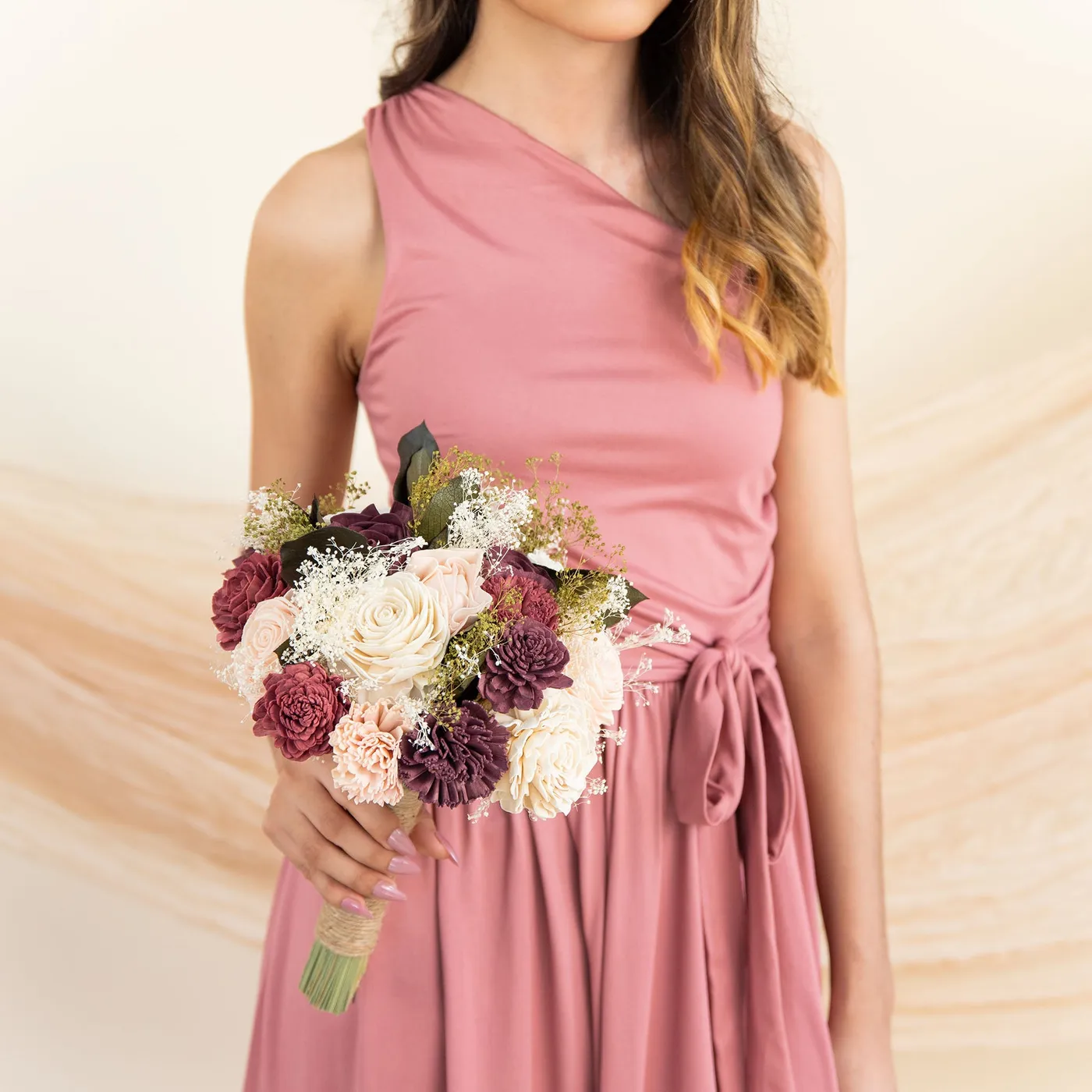 Bridesmaid in a pink dress holding the Love Story Bridesmaid Bouquet