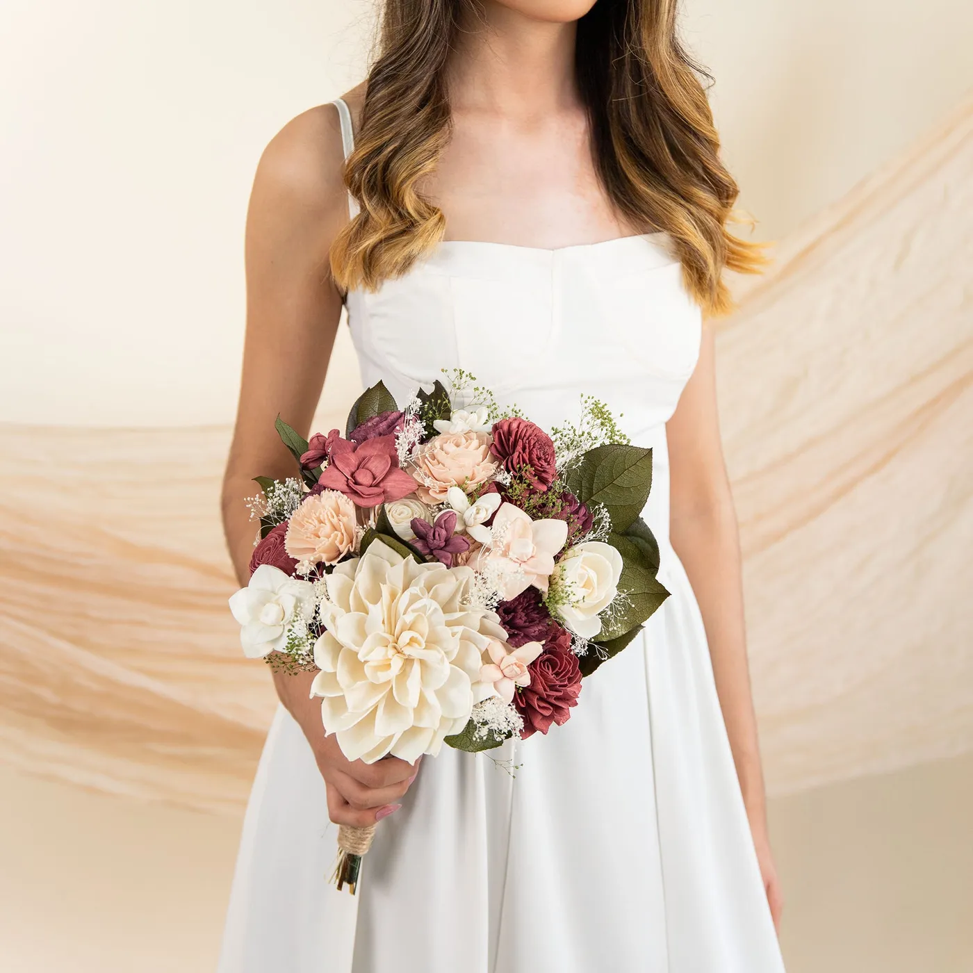 Bride holding the Wild Style Love Story Bridal Bouquet with a large cream bloom