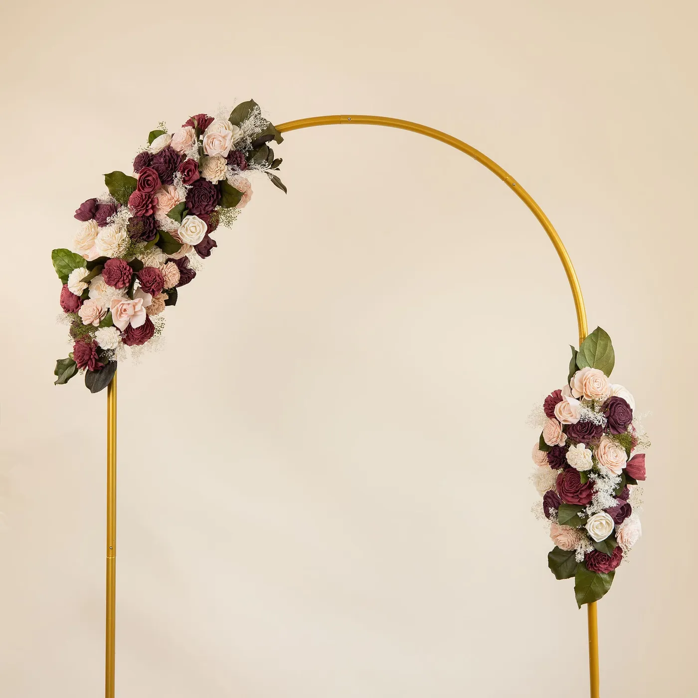 Gold wedding arch dressed with two Love Story floral sprays