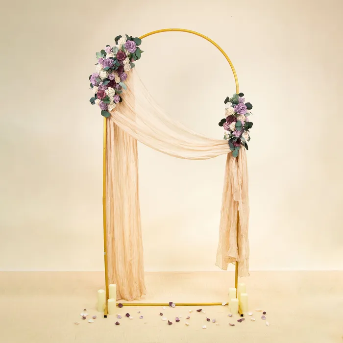 Gold arch with peach drape and two Luxe Lavender floral sprays